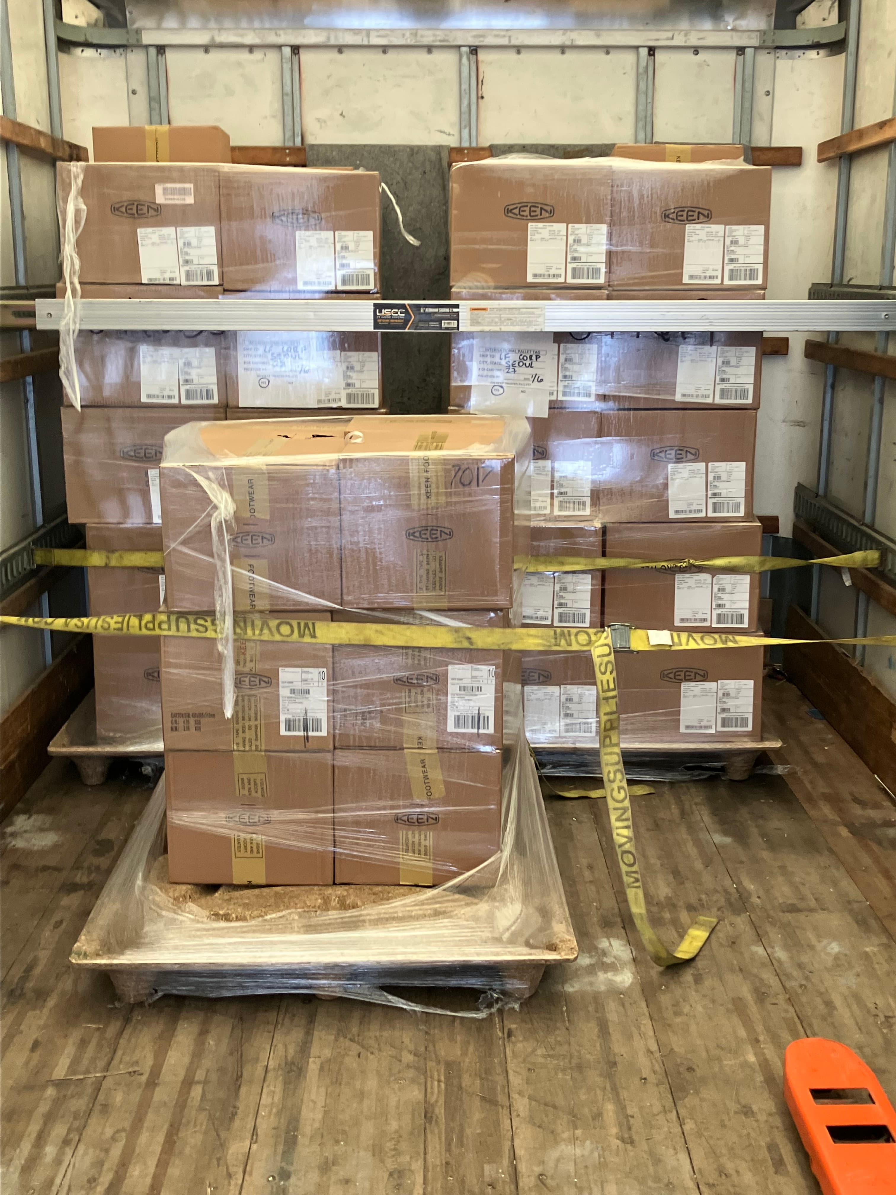 Palletized cargo strapped and load-barred inside a CMG box truck